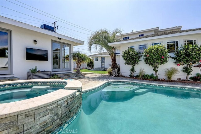 view of swimming pool with a pool with connected hot tub