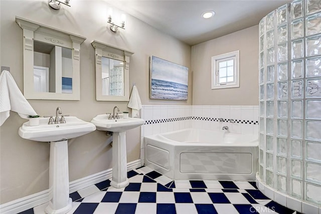 full bath with tile patterned floors, baseboards, and a bath