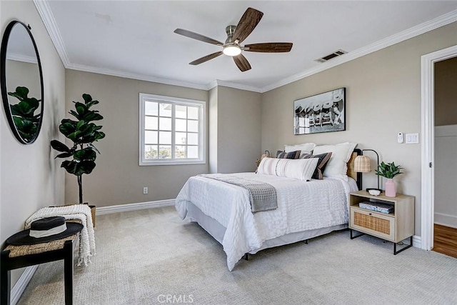 bedroom featuring visible vents, ornamental molding, baseboards, and a ceiling fan