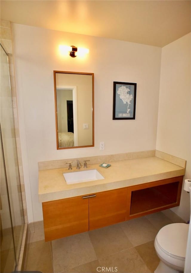 ensuite bathroom featuring vanity, tile patterned floors, toilet, and ensuite bath