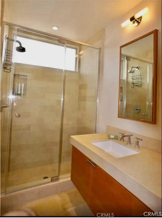 bathroom with vanity and a stall shower