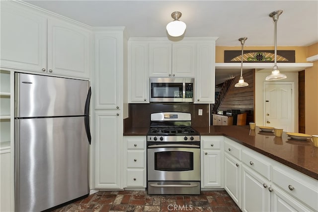 242 Holiday Dr, Lake Arrowhead, CA 92352 - kitchen with decorative light fixtures, tasteful backsplash, brick floor, stainless steel appliances, and white cabinetry