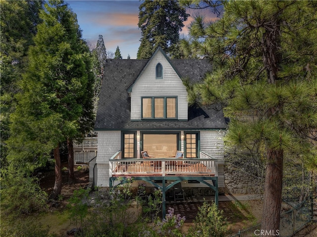 242 Holiday Dr, Lake Arrowhead, CA 92352 - back of house at dusk featuring roof with shingles and a deck