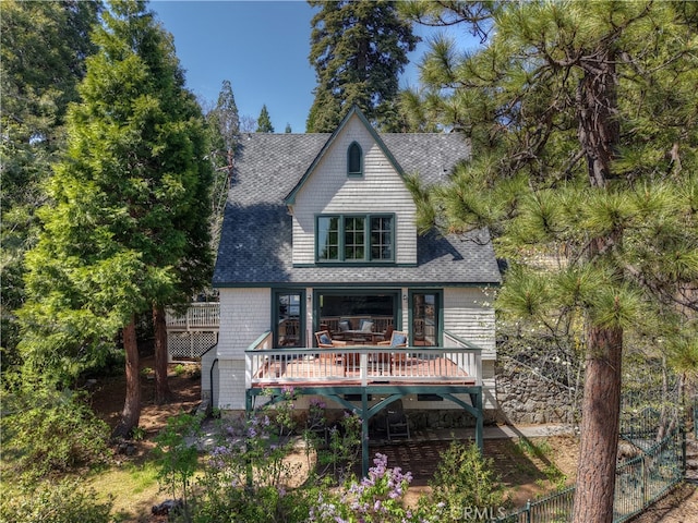 242 Holiday Dr, Lake Arrowhead, CA 92352 - rear view of house featuring fence, a shingled roof, and a wooden deck