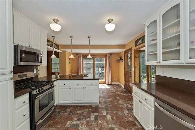 242 Holiday Dr, Lake Arrowhead, CA 92352 - kitchen featuring dark countertops, stainless steel appliances, baseboards, a peninsula, and glass insert cabinets