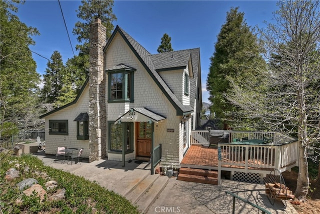 242 Holiday Dr, Lake Arrowhead, CA 92352 - back of property featuring a chimney, a deck, roof with shingles, and a patio
