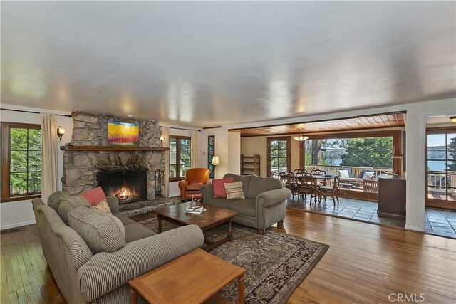242 Holiday Dr, Lake Arrowhead, CA 92352 - living room featuring wood-type flooring, healthy amount of natural light, and a fireplace