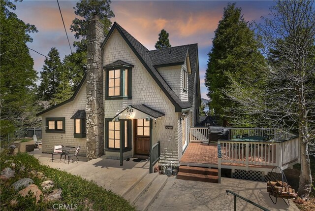 242 Holiday Dr, Lake Arrowhead, CA 92352 - back of house with a patio area, a chimney, a shingled roof, and a wooden deck