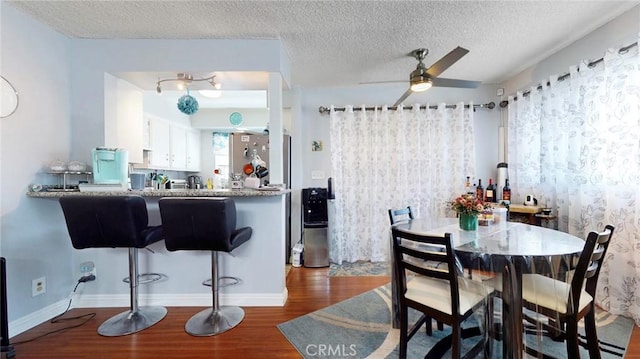 330 N Howard St Unit 212, Glendale, CA 91206 - dining room featuring baseboards, a ceiling fan, a textured ceiling, and wood finished floors