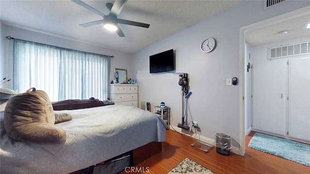 330 N Howard St Unit 212, Glendale, CA 91206 - bedroom with ceiling fan, a textured ceiling, baseboards, wood finished floors, and visible vents