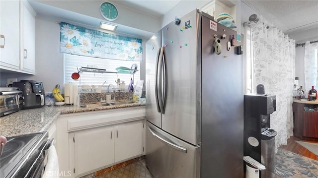 330 N Howard St Unit 212, Glendale, CA 91206 - kitchen featuring stainless steel appliances, white cabinetry, a sink, and plenty of natural light