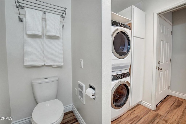 385 E Surfside Dr, Port Hueneme, CA 93041 - clothes washing area with laundry area, heating unit, stacked washer / dryer, light wood-style floors, and baseboards