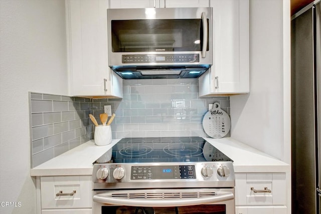 385 E Surfside Dr, Port Hueneme, CA 93041 - kitchen with light countertops, backsplash, stainless steel appliances, and white cabinetry