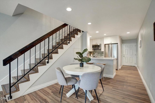 385 E Surfside Dr, Port Hueneme, CA 93041 - dining area with stairs, baseboards, and light wood-style flooring