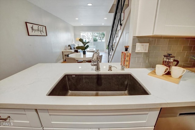 385 E Surfside Dr, Port Hueneme, CA 93041 - kitchen with backsplash, light stone countertops, a sink, white cabinets, and recessed lighting