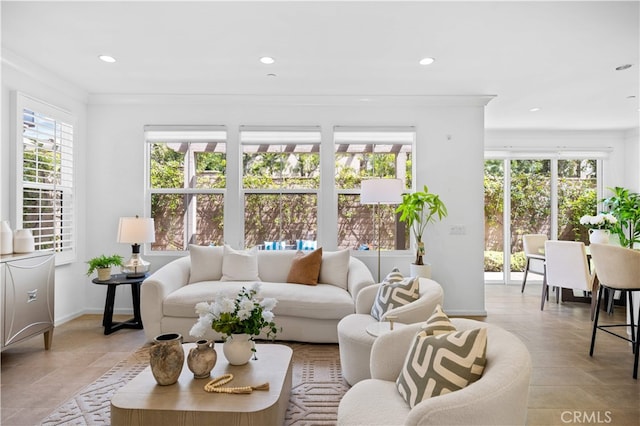 living area with light tile patterned floors, baseboards, plenty of natural light, and recessed lighting