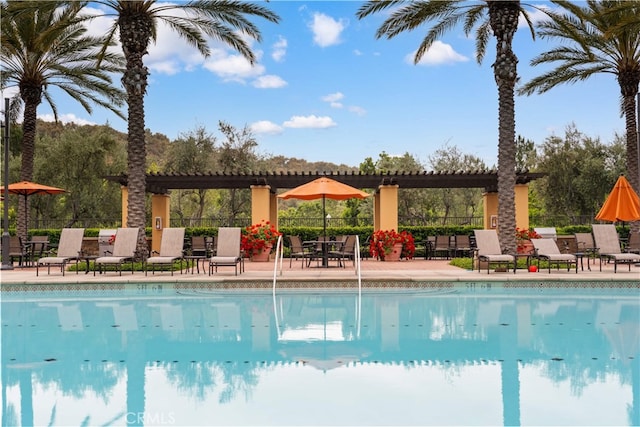 community pool featuring a patio area and fence