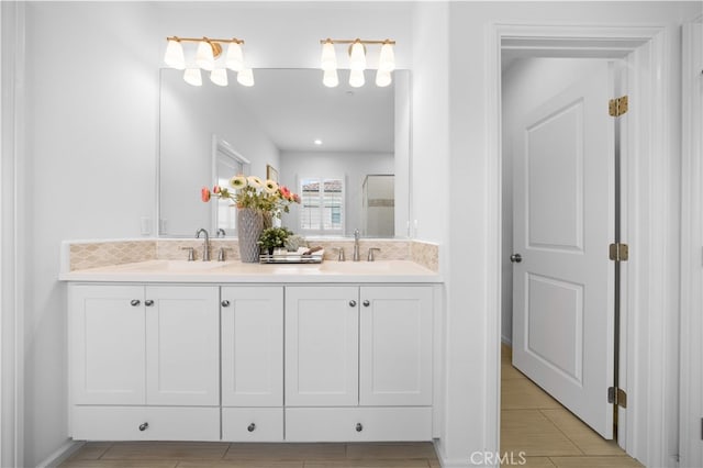 bathroom with a sink, tasteful backsplash, and double vanity