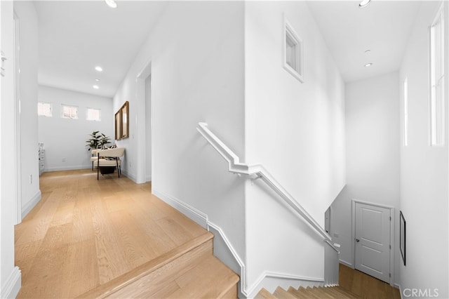 stairs featuring recessed lighting, baseboards, and wood finished floors