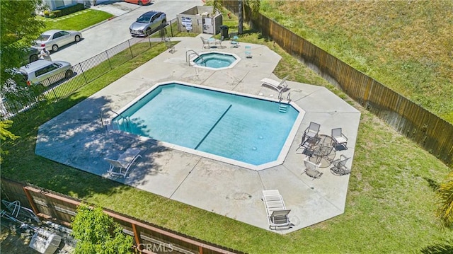 community pool with a patio and a community hot tub