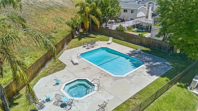 community pool with a community hot tub and a patio