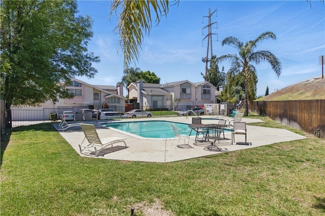 community pool with a patio area and a residential view