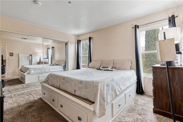 bedroom featuring carpet, a closet, and baseboards