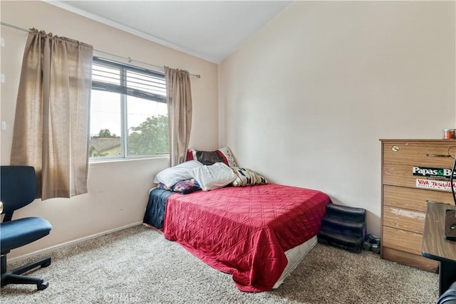 bedroom with carpet, lofted ceiling, and baseboards
