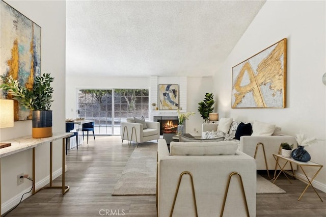 20905 Trigger Ln, Diamond Bar, CA 91765 - living room with a textured ceiling, wood finished floors, a brick fireplace, and baseboards