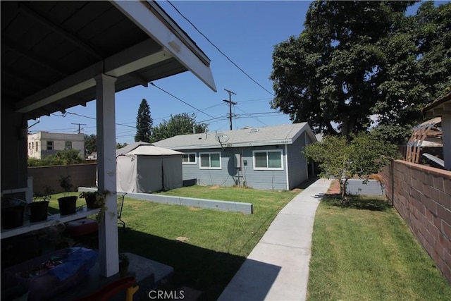 view of front of home with a front lawn and fence