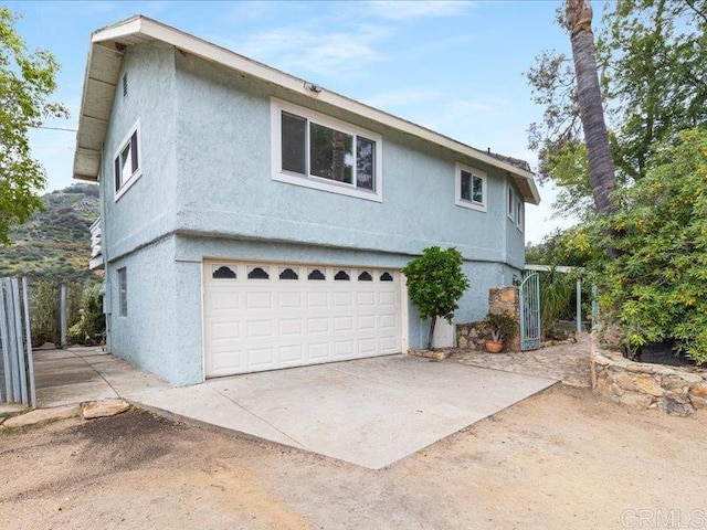 view of front of home featuring an attached garage and stucco siding