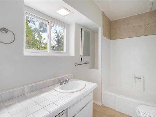 bathroom with toilet, bathtub / shower combination, tile patterned flooring, and vanity