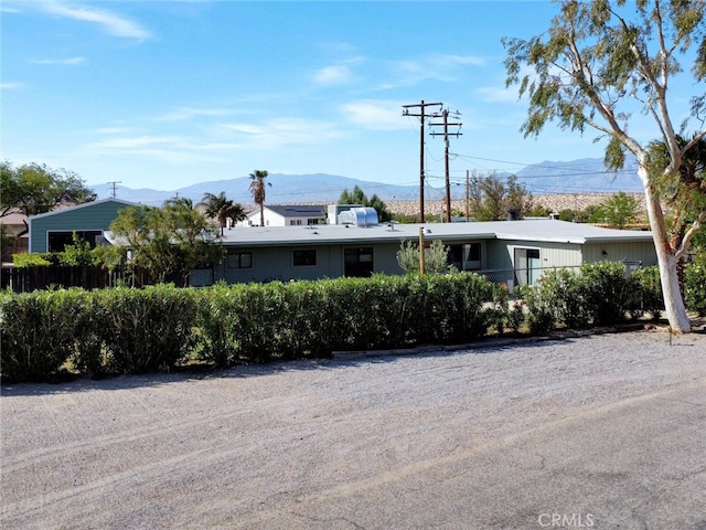view of front of property with fence and a mountain view