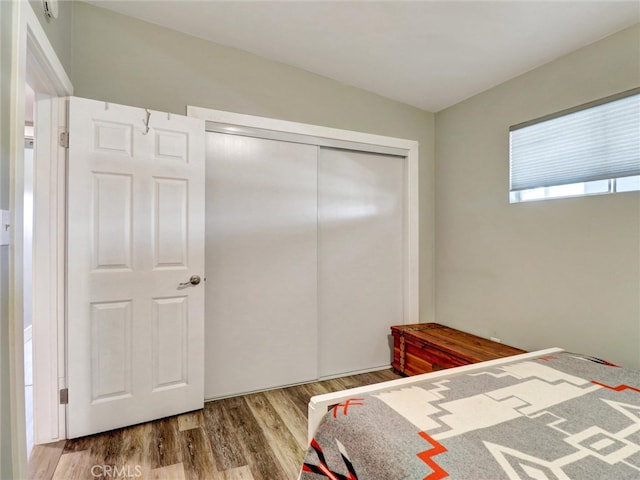 bedroom with a closet and wood finished floors