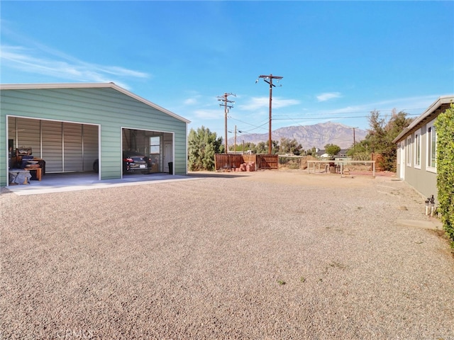 view of yard with a mountain view, an outbuilding, and a detached garage
