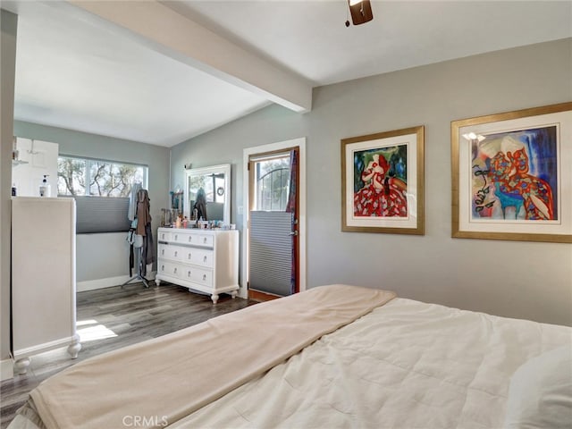 bedroom with lofted ceiling with beams, baseboards, a ceiling fan, and wood finished floors