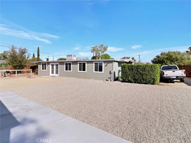 manufactured / mobile home featuring french doors and fence