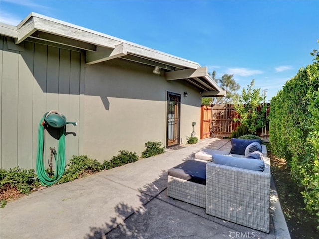 view of side of home with a patio and fence