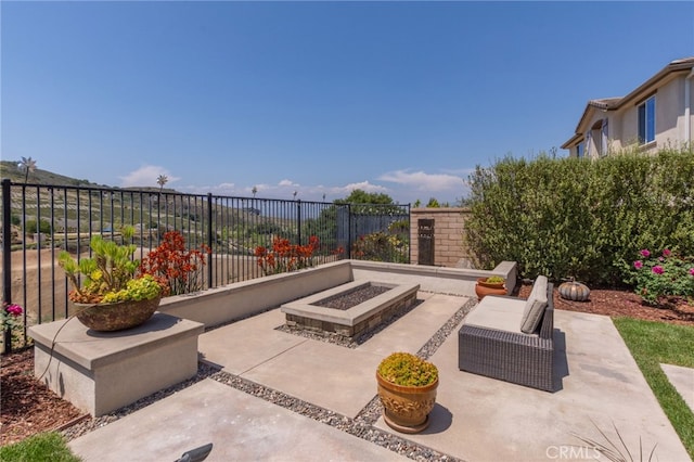 view of patio / terrace with an outdoor fire pit and fence