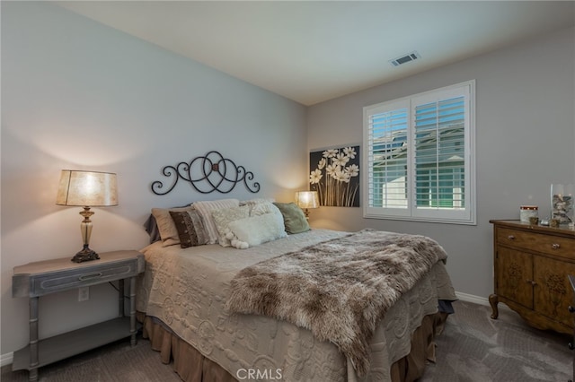 bedroom with visible vents, carpet, and baseboards