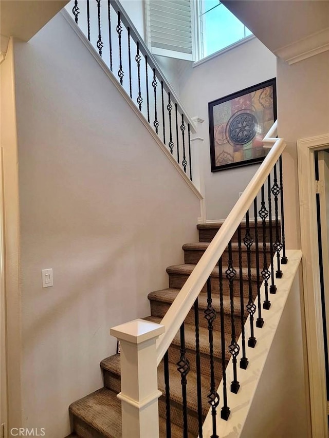 staircase with a towering ceiling