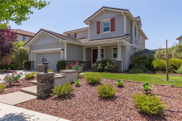 craftsman house with a garage, a porch, and stone siding