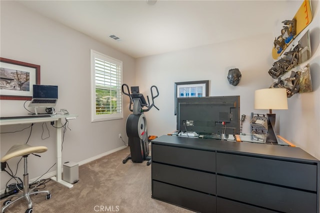 carpeted home office with visible vents and baseboards