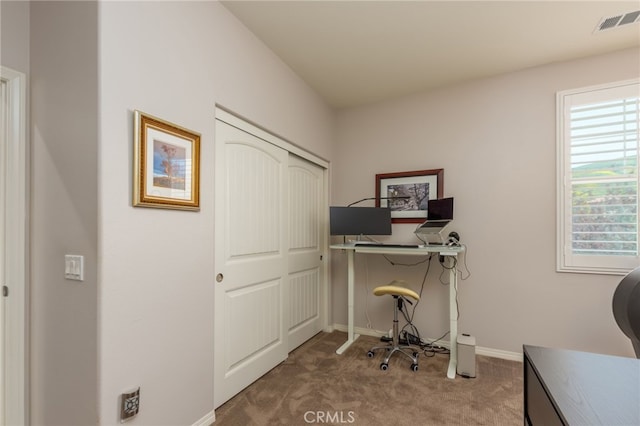 carpeted office with baseboards and visible vents