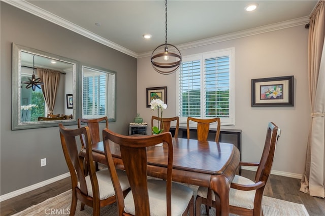 dining space featuring plenty of natural light, ornamental molding, baseboards, and wood finished floors