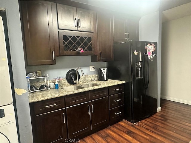 bar with dark wood-style flooring, baseboards, a sink, and black fridge with ice dispenser