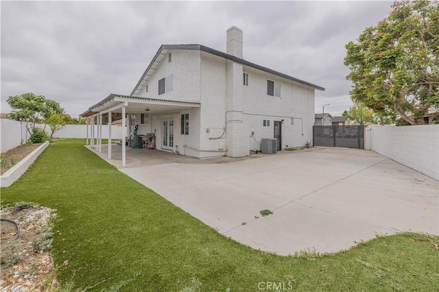 12246 Nadine Cir, Garden Grove, CA 92840 - rear view of property featuring a chimney, a patio area, central air condition unit, a fenced backyard, and a yard