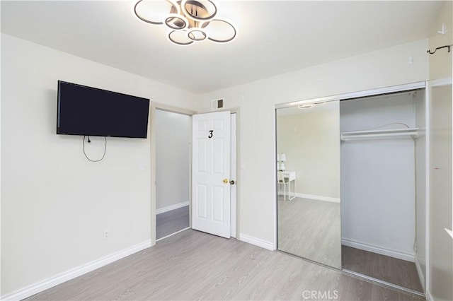 12246 Nadine Cir, Garden Grove, CA 92840 - unfurnished bedroom featuring baseboards, visible vents, wood finished floors, and a closet