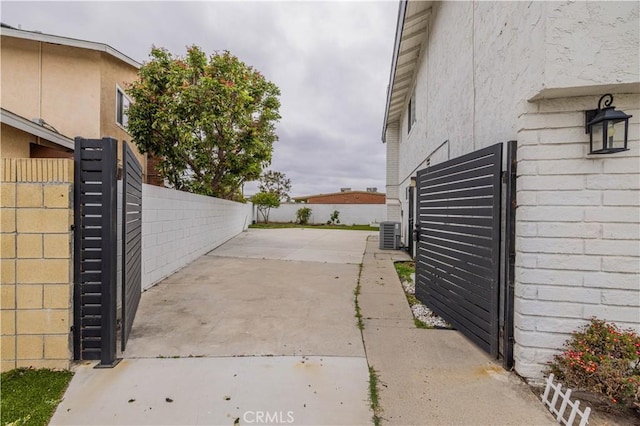 12246 Nadine Cir, Garden Grove, CA 92840 - view of gate featuring fence, central air condition unit, and a patio area