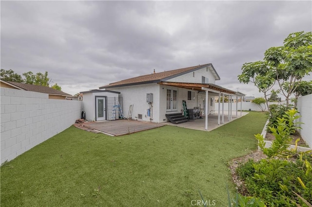 12246 Nadine Cir, Garden Grove, CA 92840 - rear view of property featuring a yard, a fenced backyard, and stucco siding
